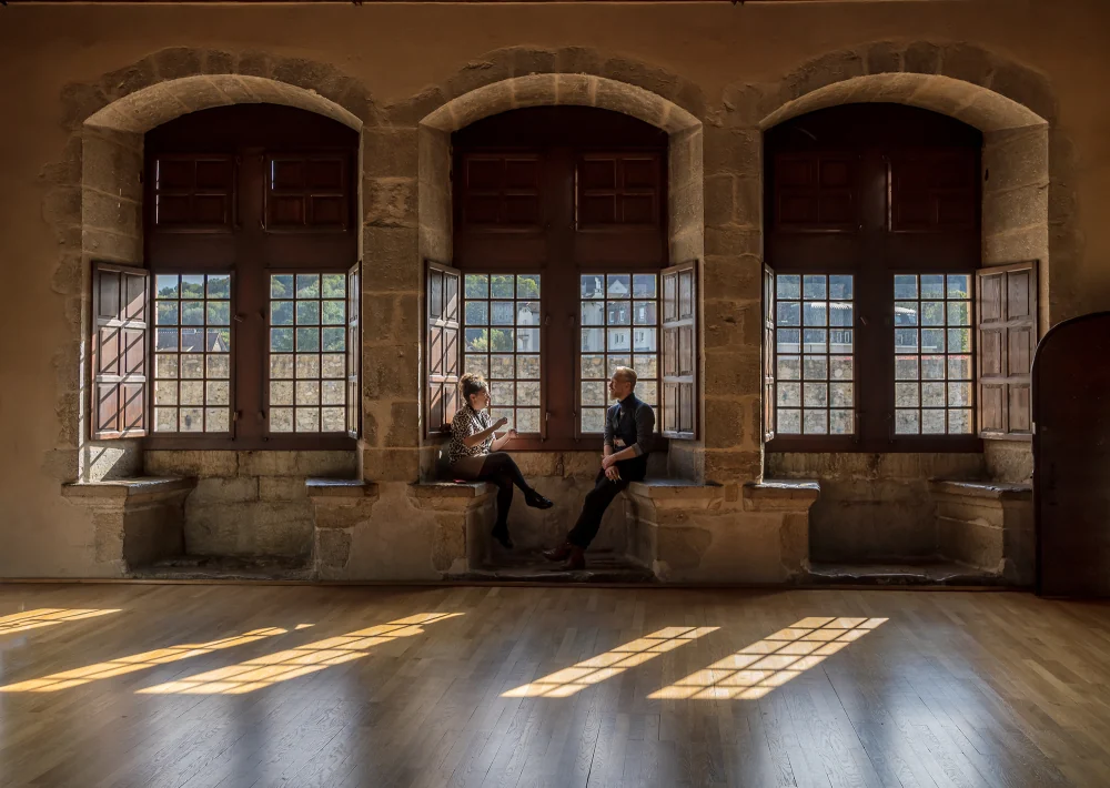 Historic room lit by three large windows